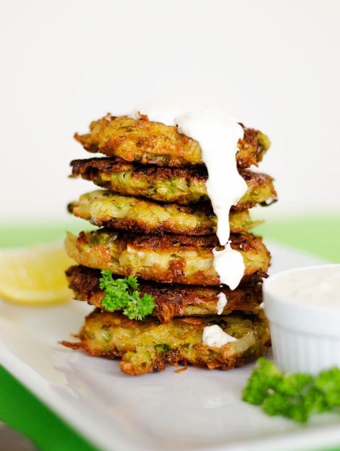 a stack of food sitting on top of a white plate next to a small bowl