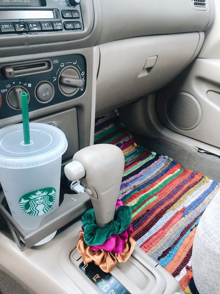 a starbucks cup sitting on the dashboard of a car