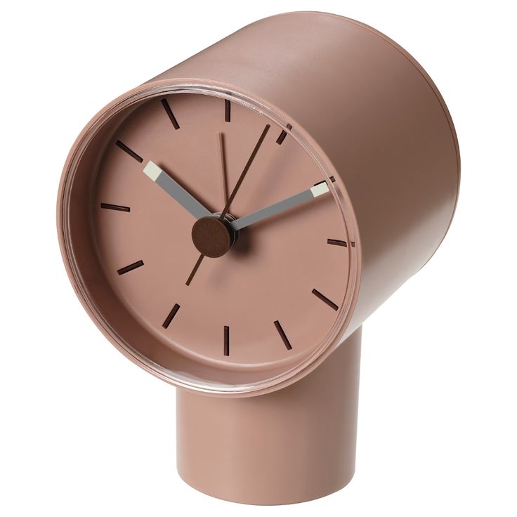 a pink clock is on top of a brown stand with silver hands and two black numbers