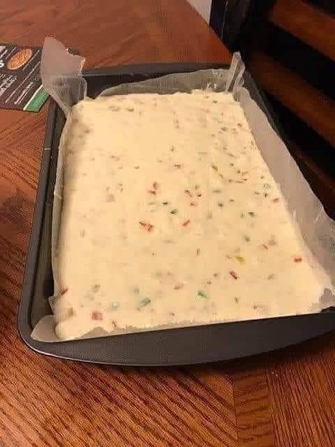 a pan filled with batter sitting on top of a wooden table