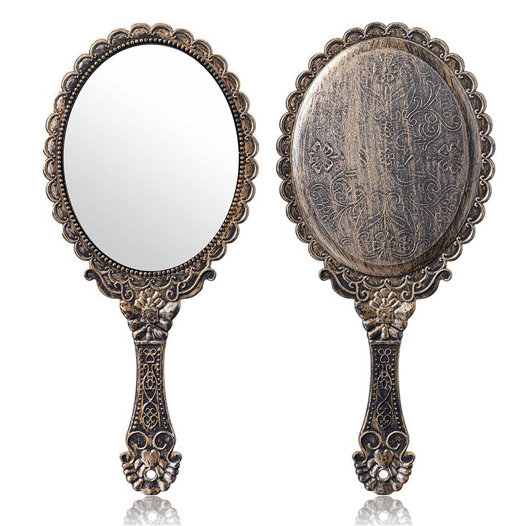 an ornately decorated mirror and stand on a white background with reflection in the mirror