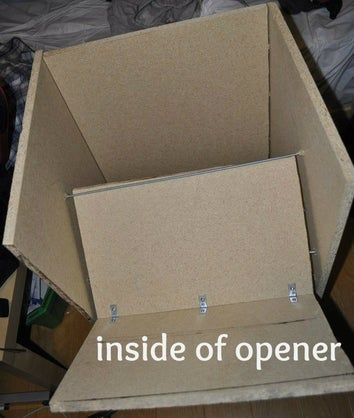 an open cardboard box sitting on top of a bed