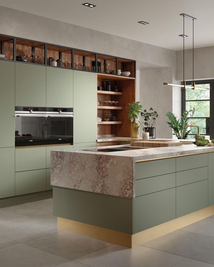 a modern kitchen with green cabinets and marble counter tops