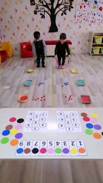 two children are playing with numbers on the floor