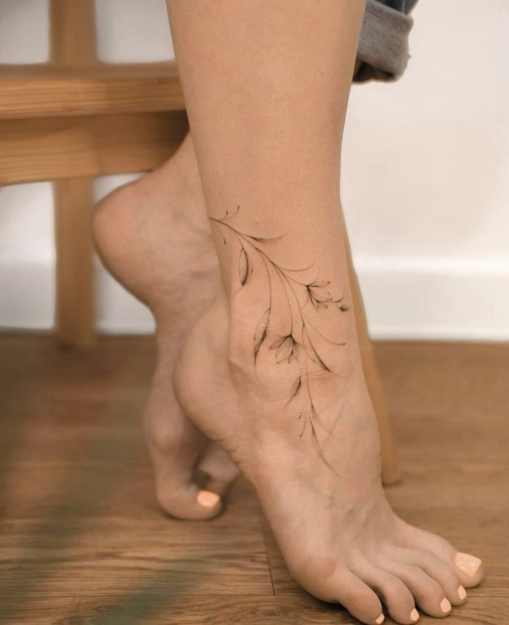 a woman's foot with a tattoo on it