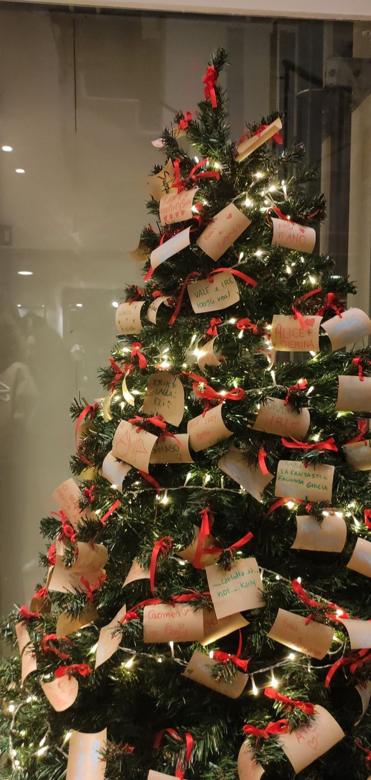 a christmas tree decorated with tags and lights