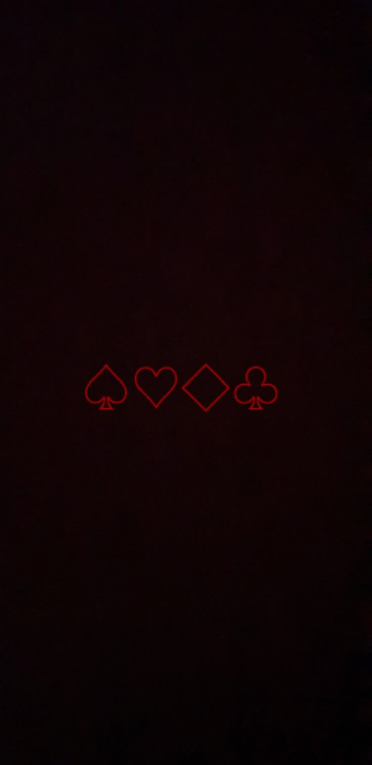 three hearts and four spades on a black background with red light in the middle