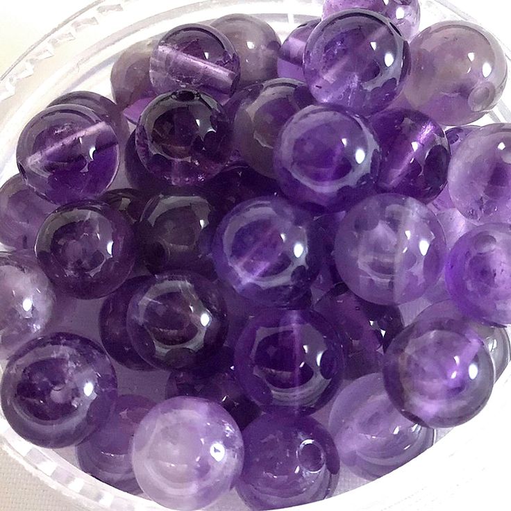 a bowl filled with lots of purple marbles