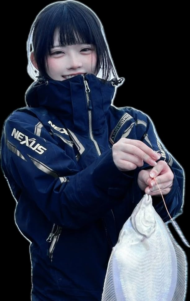 a woman holding a white fish in her right hand and wearing a blue jacket with the words nexis on it