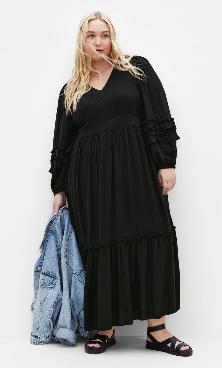 Impress them all with the Malia Plain Maxi Dress. The V neckline adds a classic yet flattering touch to your look. Complete with a relaxed tiered skirt and long sleeves, take your styling to new heights with this dress. Key Features Include: - V neckline - Long sleeves w/elastic cuff - Side invisible zip closure - Functional side pockets - Partially lined - Relaxed tiered skirt - Maxi length Pair with embellished heels for date night. | Plus Size Malia Plain Maxi Dress in Black, Size 16 | City C Date Night Plus Size, Plain Maxi Dress, Maxi Dress Plus Size, Dresses Date Night, Embellished Heels, Skirt Maxi, Plus Size Maxi, Lingerie Dress, Date Night Dresses