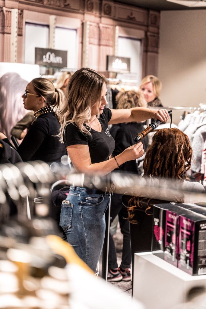 a group of women in a store getting their hair done