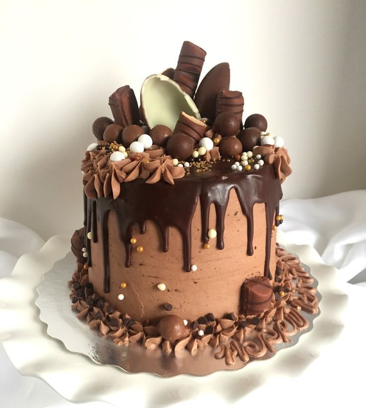 a cake with chocolate frosting and decorations on top is shown in an instagram