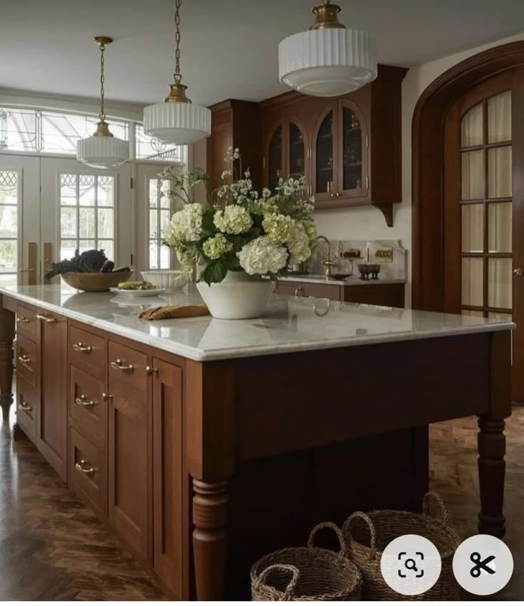 a large kitchen with an island in the middle and lots of cabinets on both sides