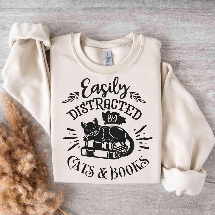 Books & Cats Shirt Sweater, reading shirt, bookmerch, Bookworm Gift, gift ideas book lovers, bookshelf, book basket, booktrovert Description of the shirt: Made from a mid-weight 50% cotton/50% polyester blend (8.0 oz/yd this sweatshirt is comfortable to wear and is the perfect choice for the colder months. The classic fit and round neckline ensure a comfortable fit with a clean cut. At the same time, the double seams on the shoulders, armholes, neck, waistband and cuffs ensure maximum durability Gift Ideas For Book Lovers, Book Basket, Cats Shirt, Book Baskets, Reading Shirts, Cat Books, Gifts For Bookworms, Book Shirts, Shirt Sweater