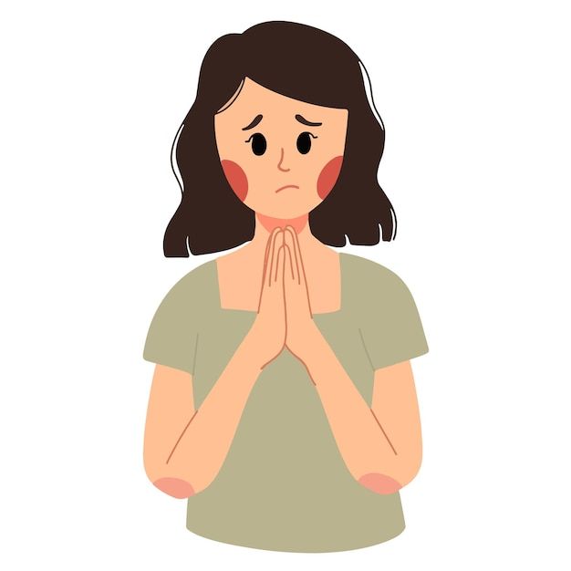 a woman is praying with her hands folded in front of her face and eyes closed