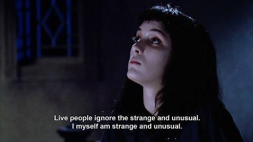 an image of a woman with dark hair in the background and text that reads, live people ignore the strange and unusual i myself