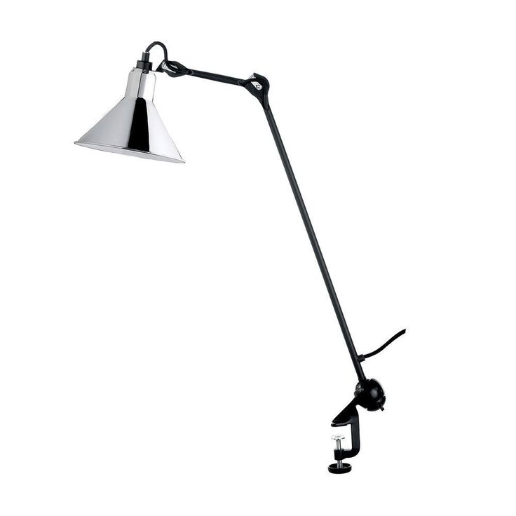 a lamp that is on top of a white wall with a black base and a silver shade