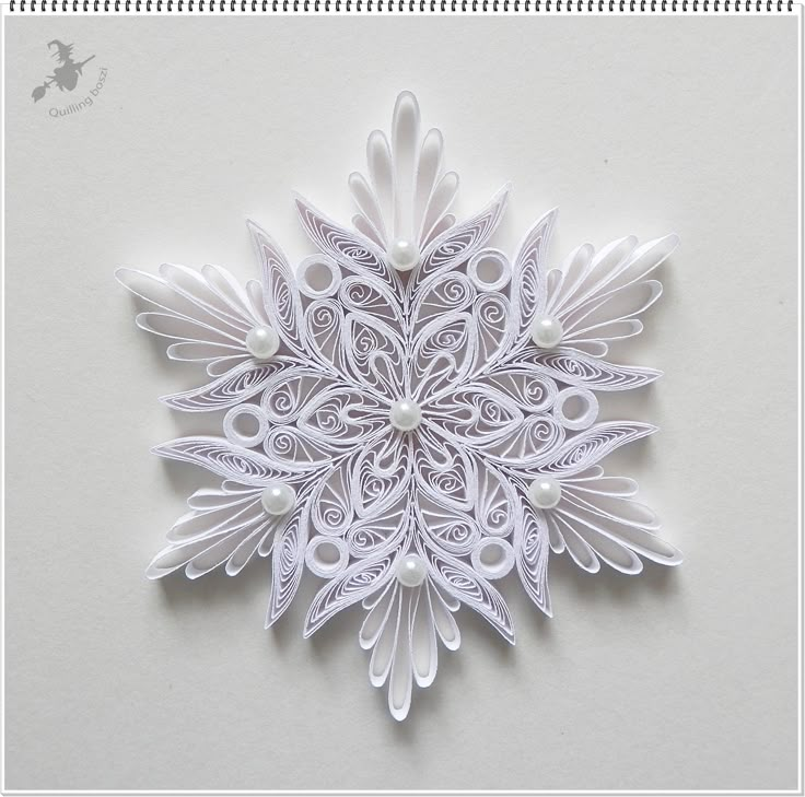 an intricate paper snowflake on a white background