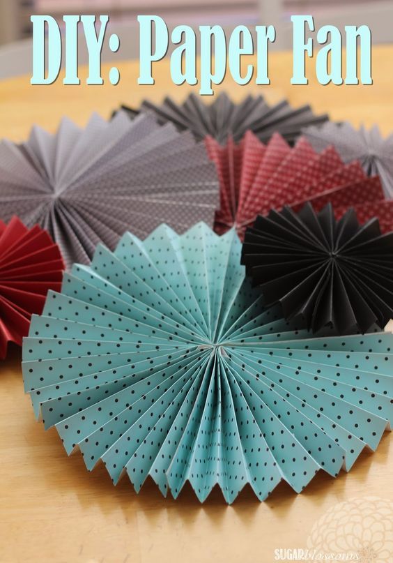 several paper fans on a table with the words diy paper fan above them in blue, red and black