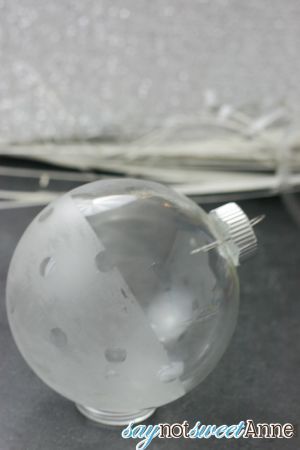 a clear glass ball ornament sitting on top of a table