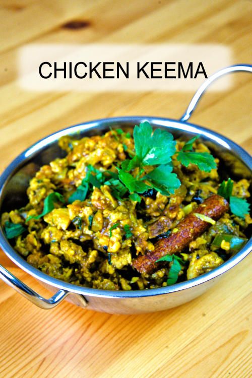 chicken keema in a metal bowl on top of a wooden table