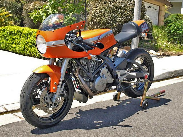 an orange motorcycle is parked on the street