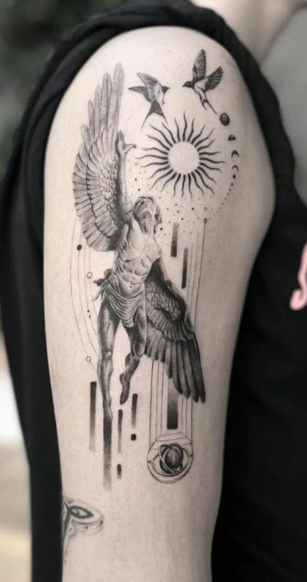 a woman's arm with a tattoo on it and birds flying over her shoulder