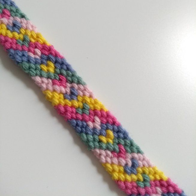 a multicolored bracelet on a white surface