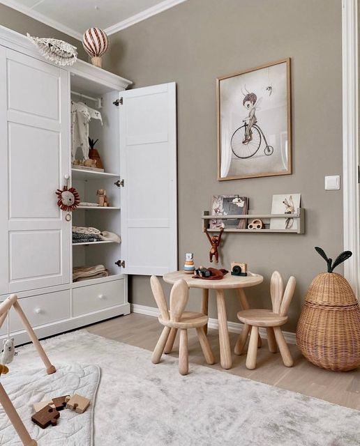 a child's room with white furniture and accessories