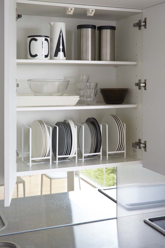 white shelves with dishes and cups on them