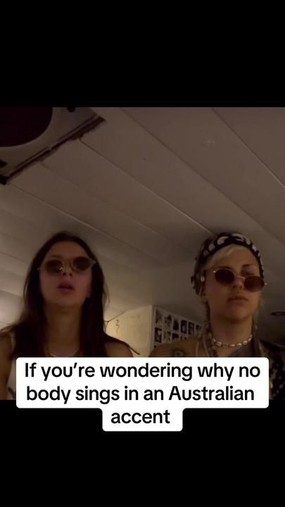 two women with sunglasses on their heads and one has an ad for the australian accent