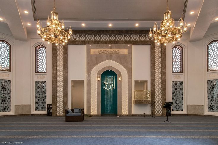 the inside of a large building with chandeliers hanging from it's ceiling