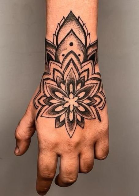 a hand with a flower tattoo on it