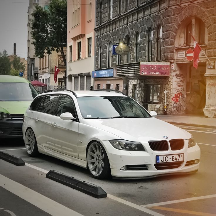 a white car is parked on the street