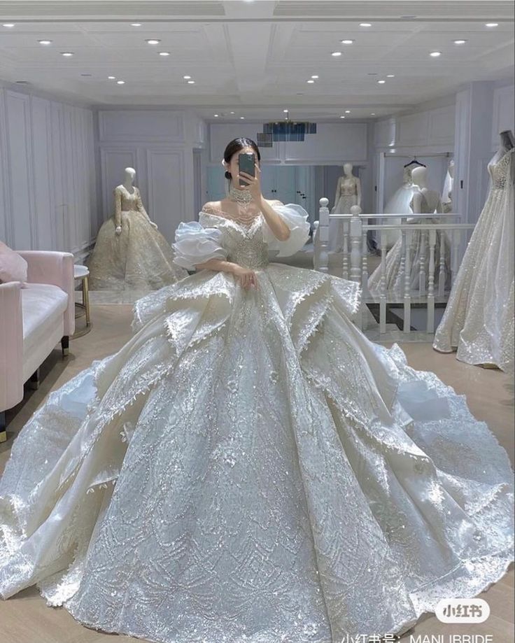 a woman is taking a selfie in a wedding dress made out of mannequins