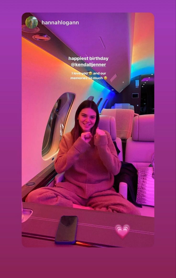 a woman sitting on top of an airplane