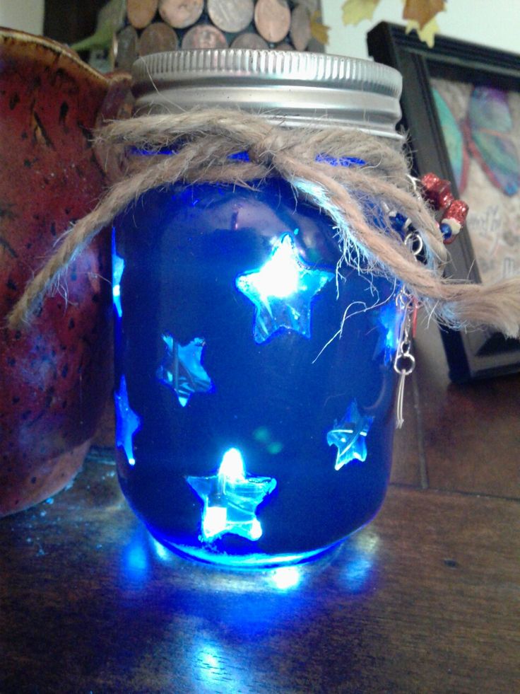 a blue jar with some lights in it