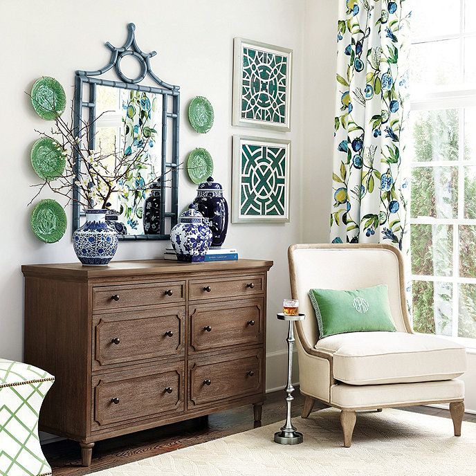 a living room scene with focus on the dresser and chair, which is decorated in blue and green