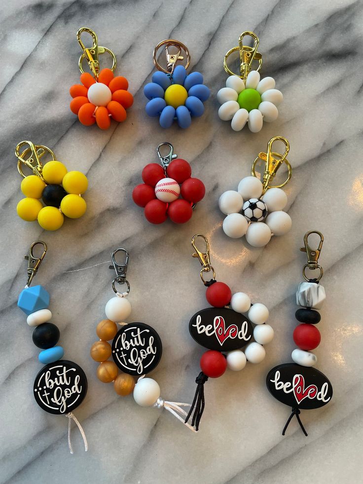 many different key chains are on a marble surface