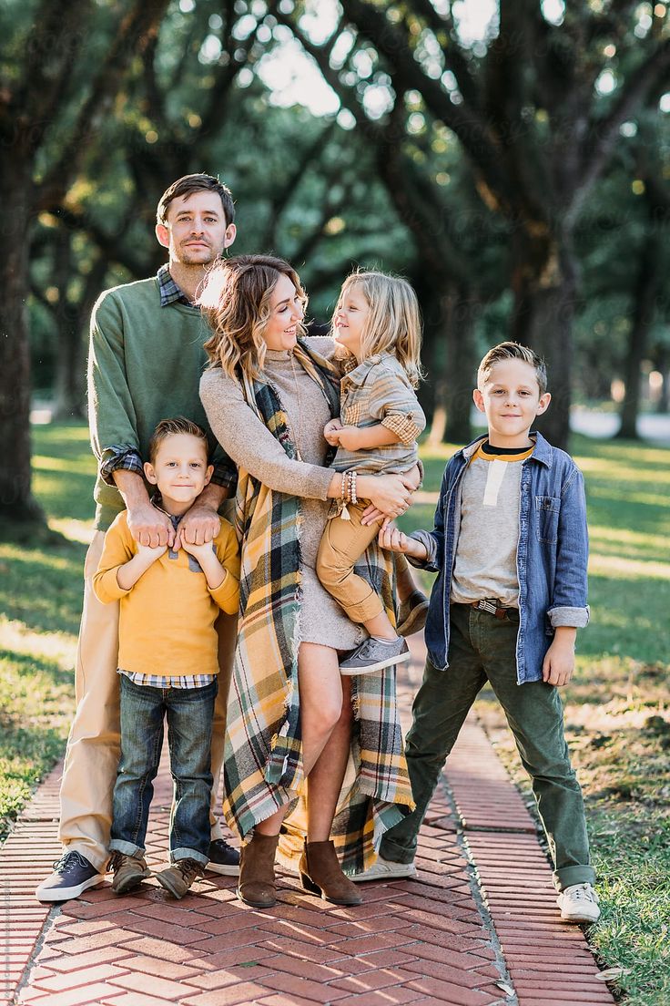 a family posing for a photo in the park