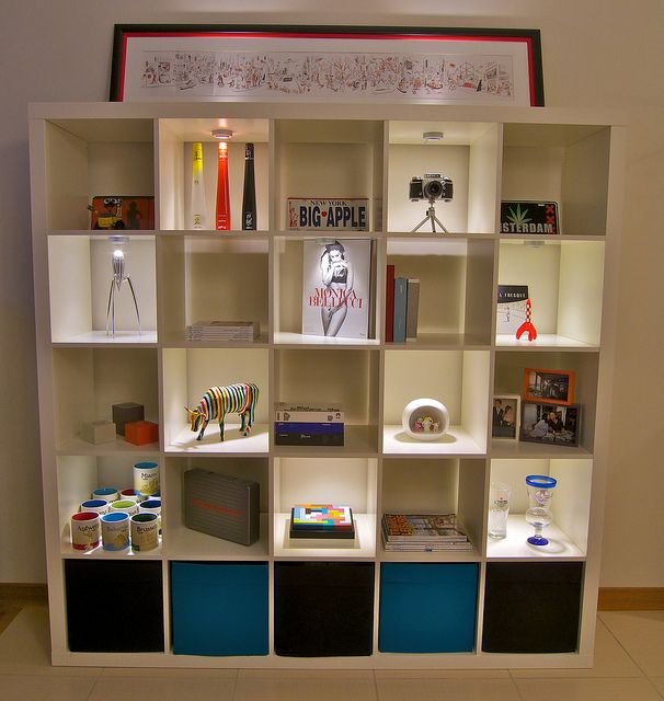 a white book shelf filled with lots of books and other items on top of it