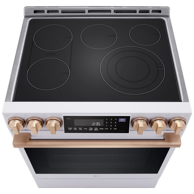 an electric stove with four burners on the front and two ovens on the back