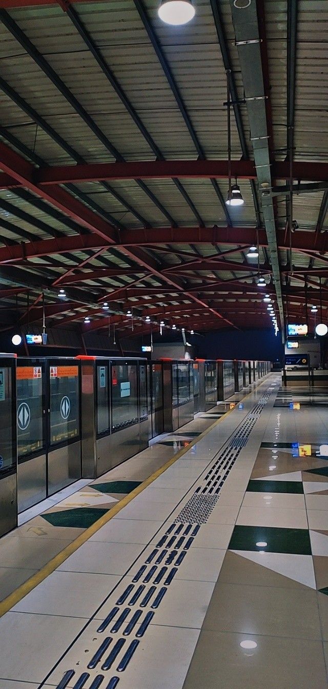 an empty train station with no people on the platform or waiting for their trains to arrive