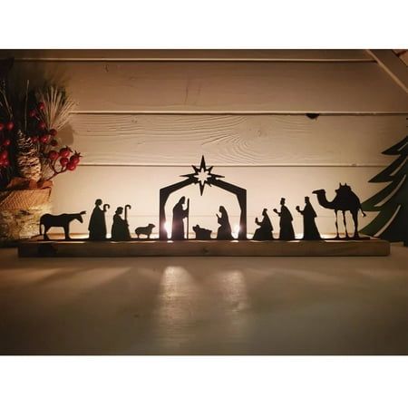 a nativity scene with the birth of jesus and three wise men in front of a christmas tree