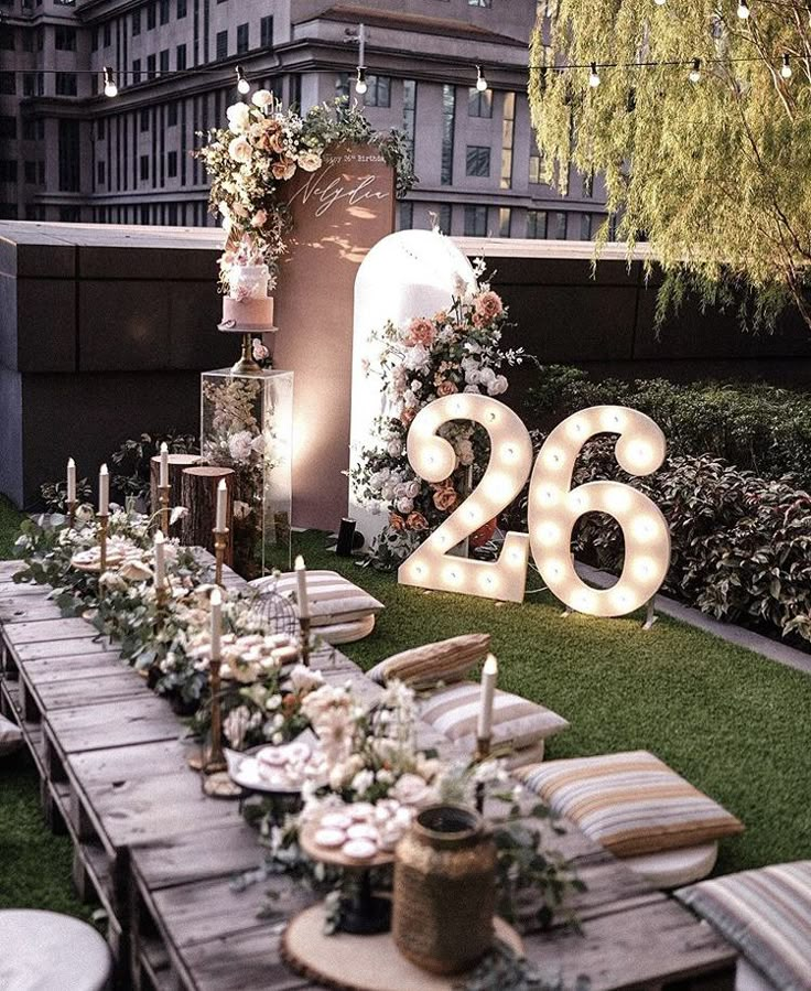 a long table is set up with flowers and candles for the guests to sit at