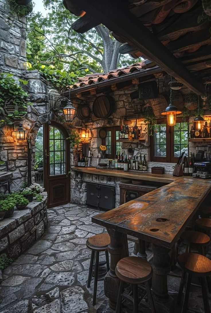 an outdoor bar with stone walls and wooden stools