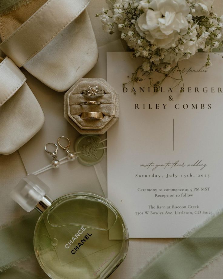 an assortment of personal items are laid out on a table with ribbons and flowers in the background