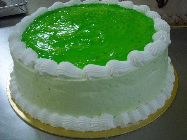 a cake with green frosting sitting on top of a table