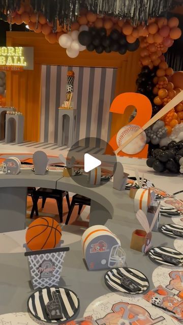 a table set up with basketball themed plates and decorations for a sports themed birthday party