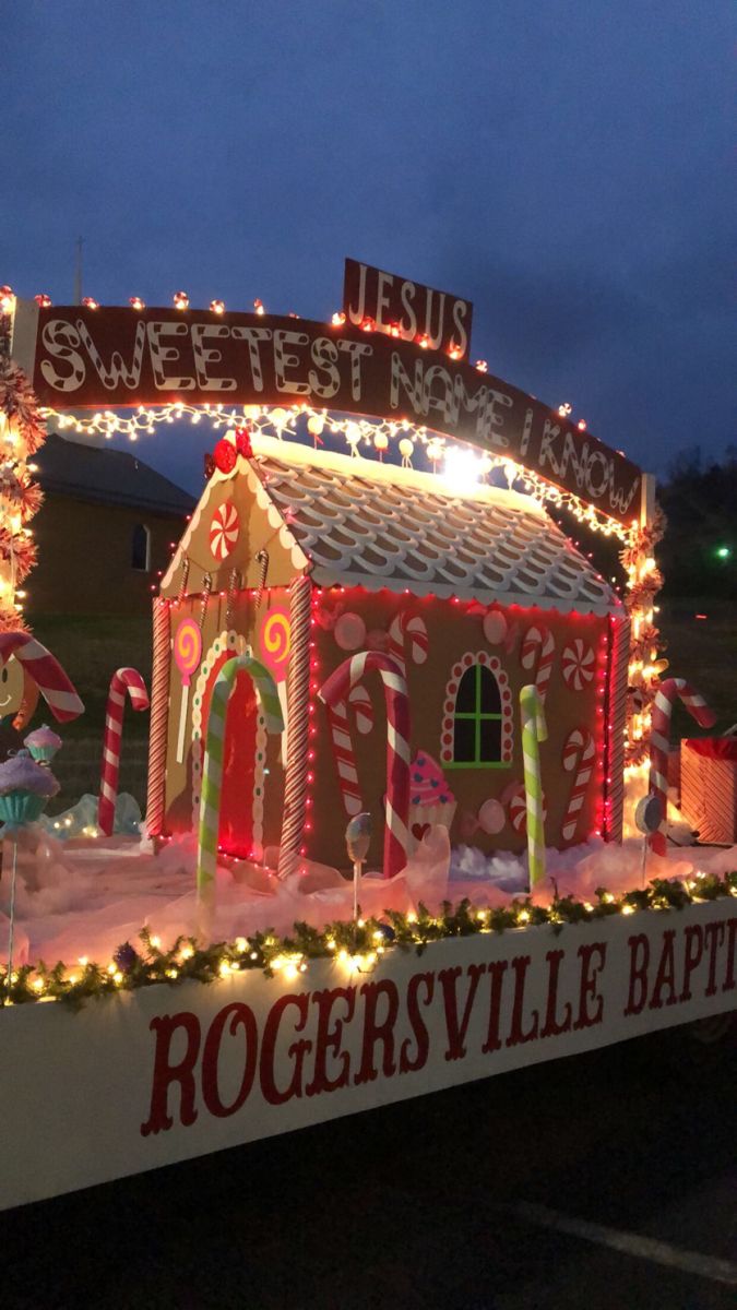 a house covered in christmas lights and candy canes on top of a boat that says rogersville baptist church